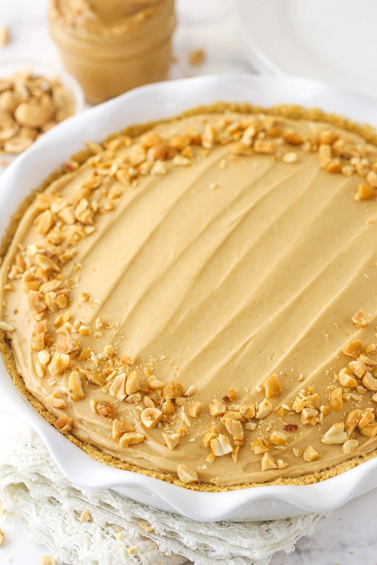 A whole peanut butter pie in a pie dish.