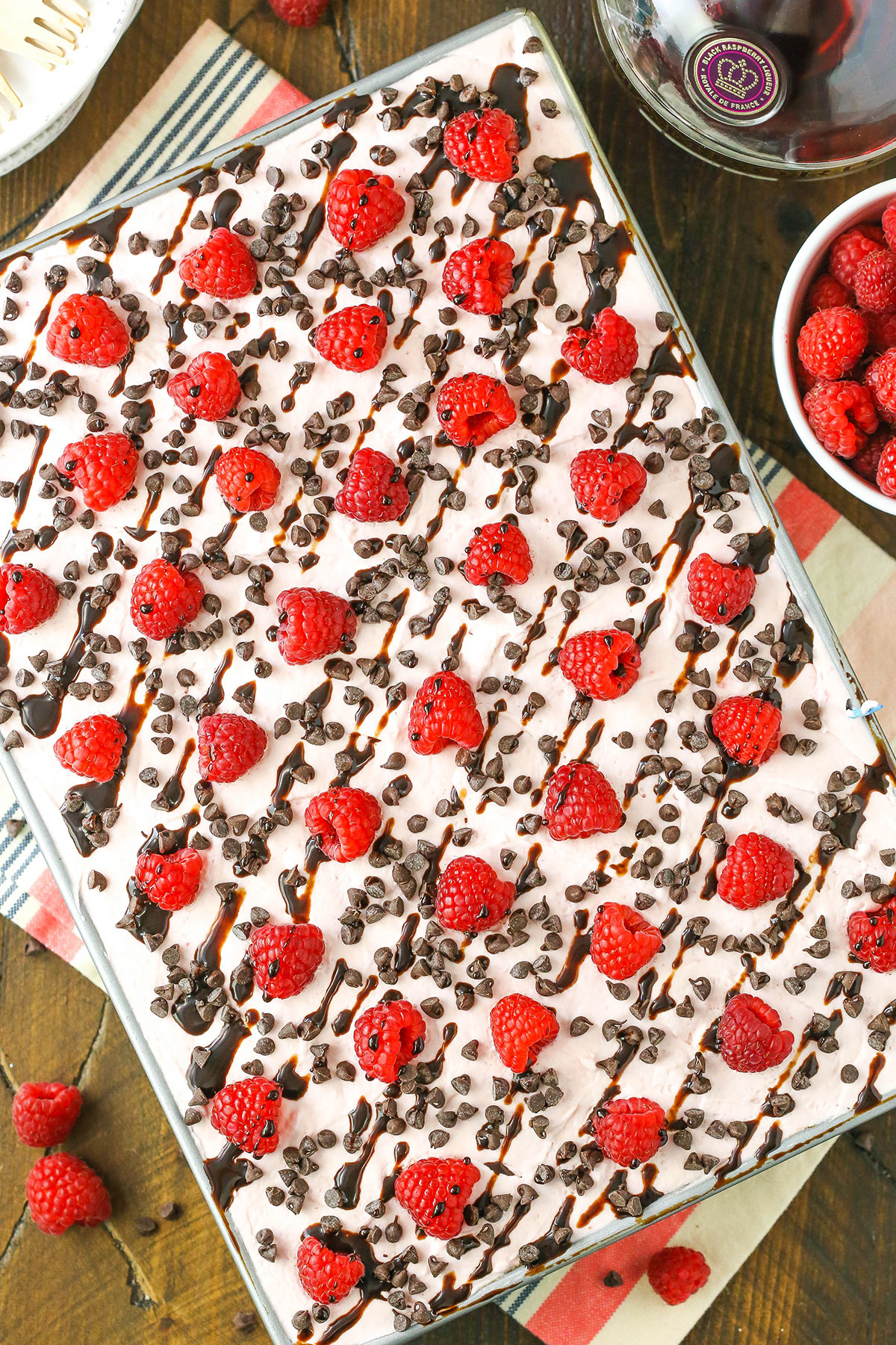 Overhead view of a full Raspberry Chambord Chocolate Poke Cake in a gray cake pan