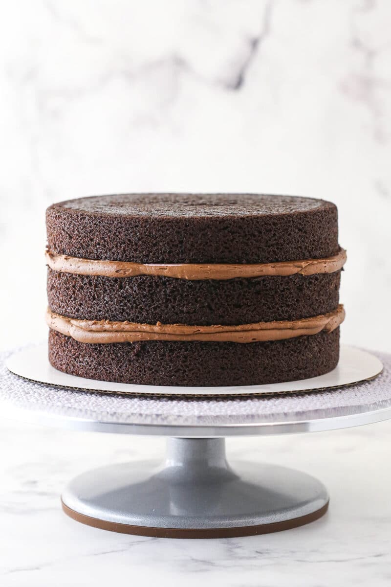3 layers of red wine chocolate cake stacked on top of one another.