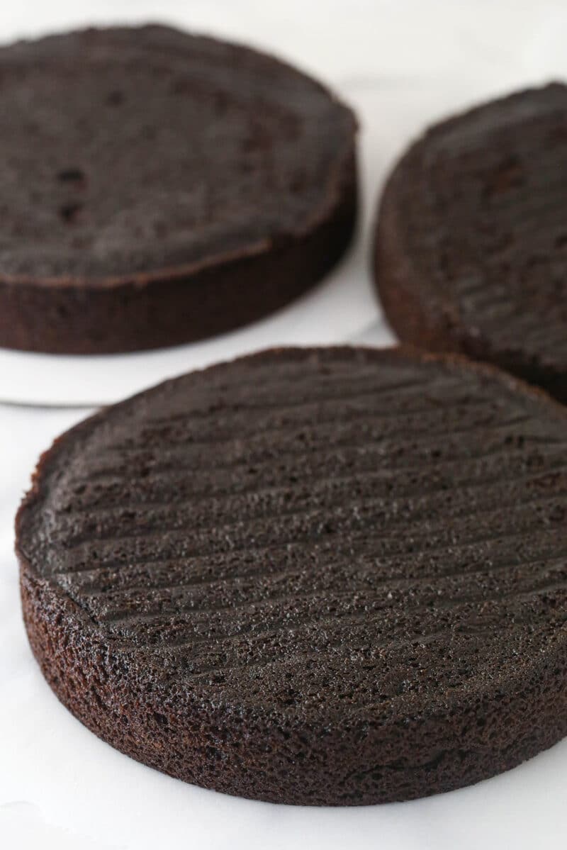 3 layers of red wine chocolate cake waiting to be stacked, filled, and frosted.