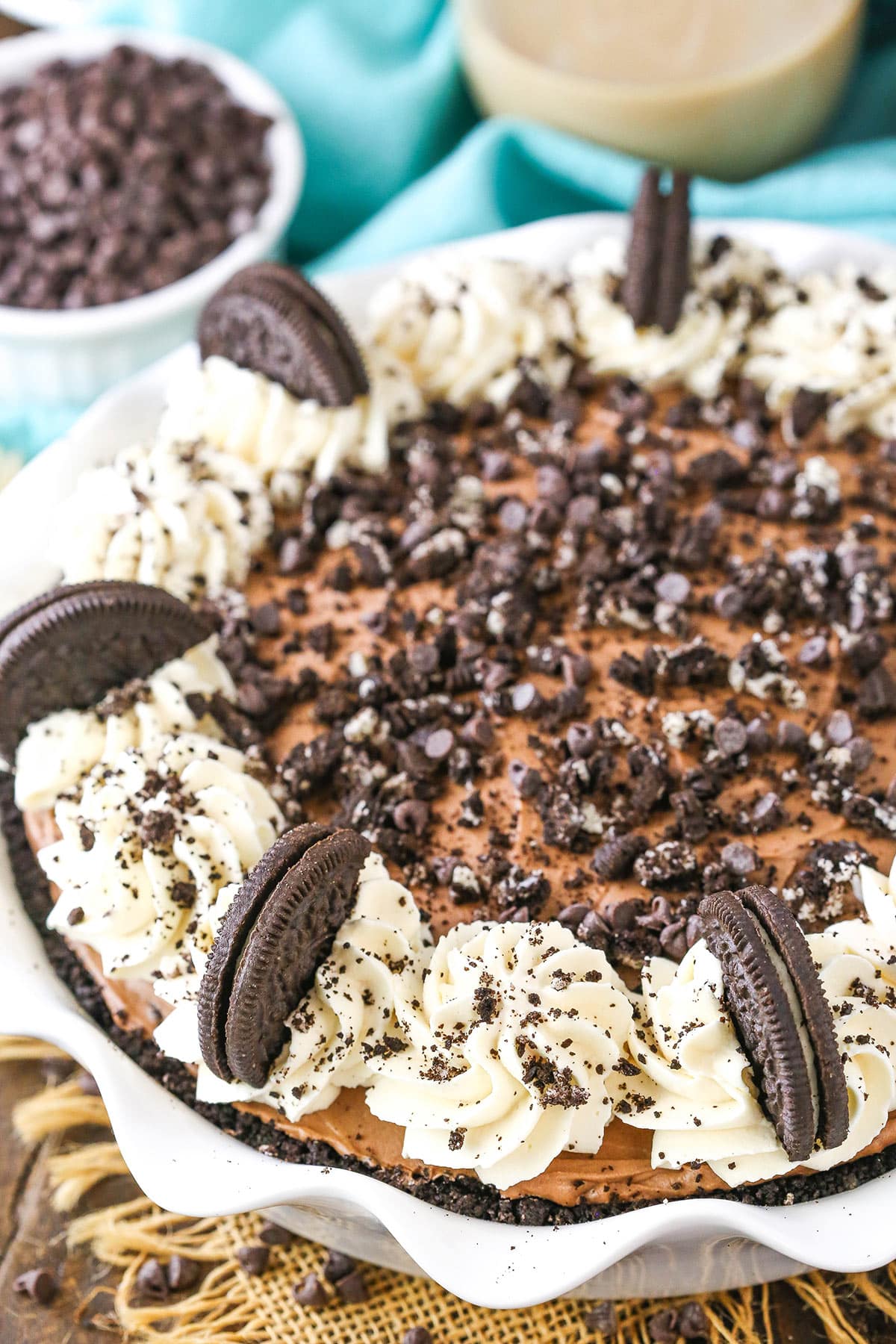 This Baileys Chocolate Cream Pie is smooth, creamy and set in an Oreo crust with a layer of Oreo crumbs throughout the center! Overhead view of a full Baileys Chocolate Cream Pie in a white platter