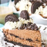 A slice of Baileys Chocolate Cream Pie next to a silver fork on a white plate