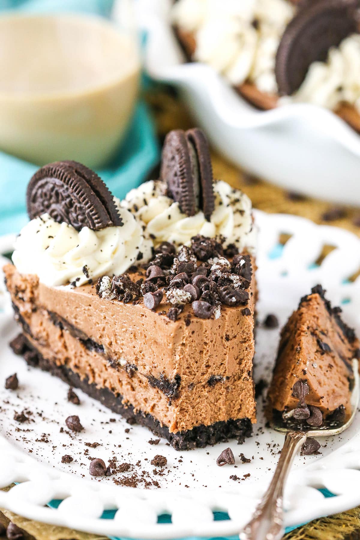 A slice of Baileys Chocolate Cream Pie with a bite removed next to a silver fork on a white plate