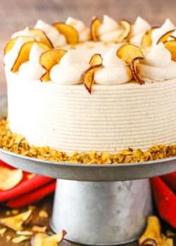 Side view of a full Cinnamon Apple Layer Cake on a gray cake stand