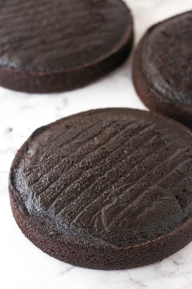 3 layers of chocolate cake ready to be stacked and frosted.