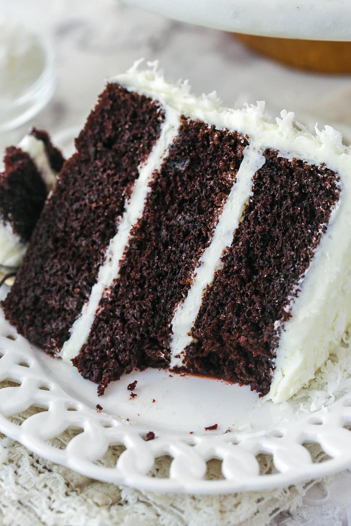 A slice of coconut chocolate cake with a bite taken out of it.