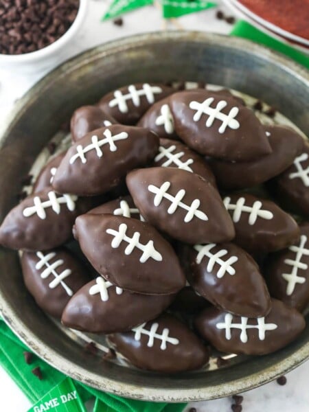 Overhead image of cookie dough footballs on a serving plate.