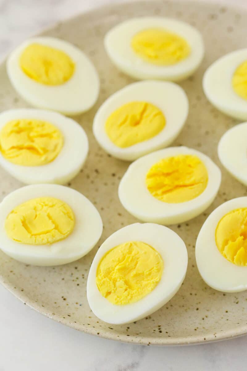 Halved hard boiled eggs on a plate.