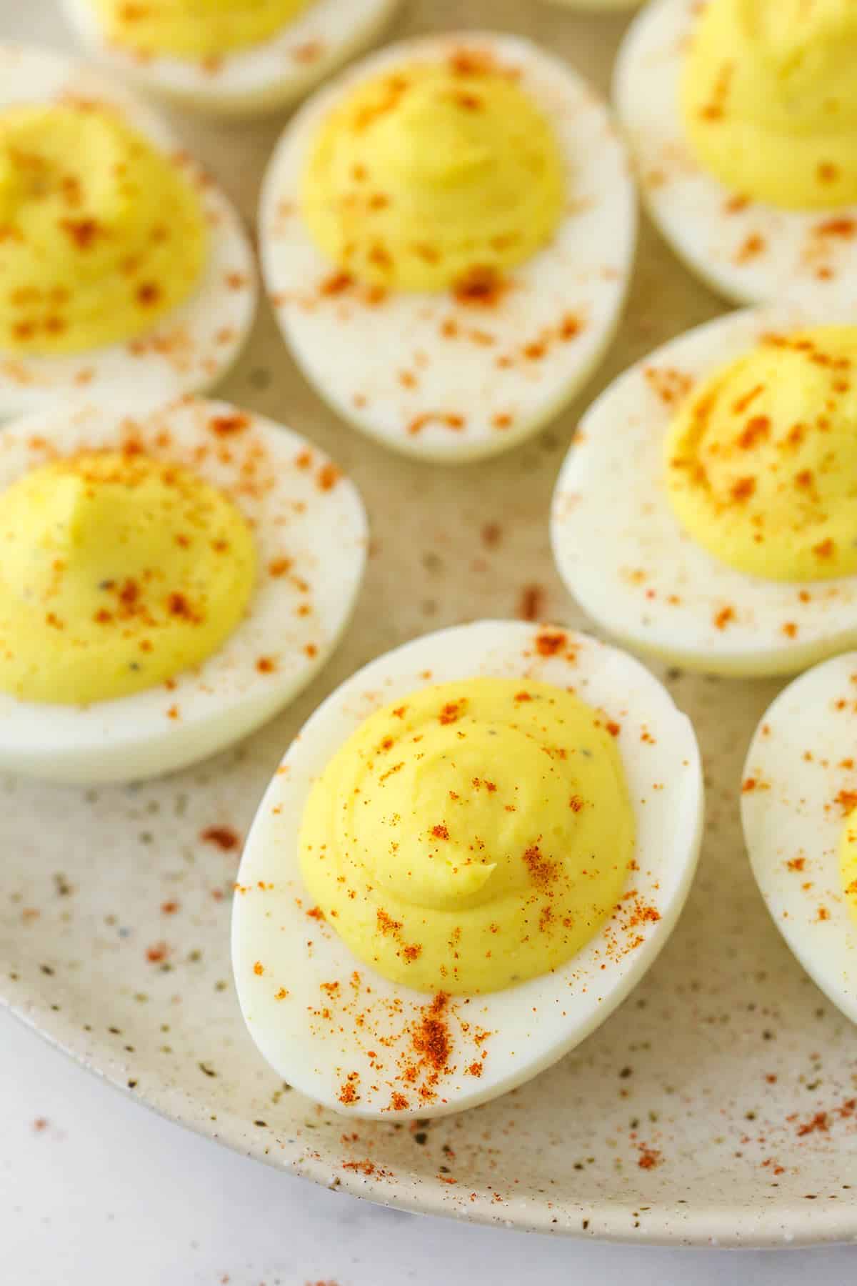 Closeup image of deviled eggs on a serving plate.