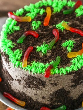Overhead view of a full Dirt Cake on a gray cake stand