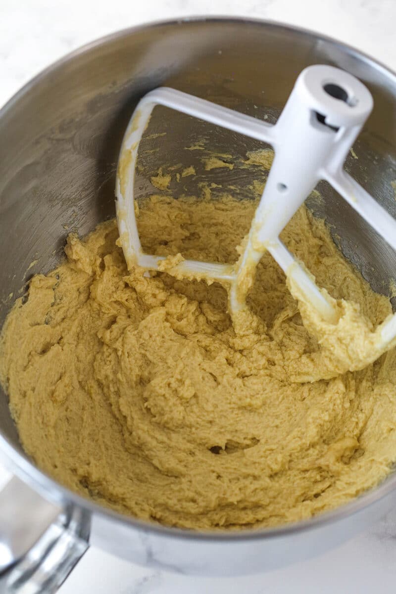 Mixing eggs into cookie cake batter.
