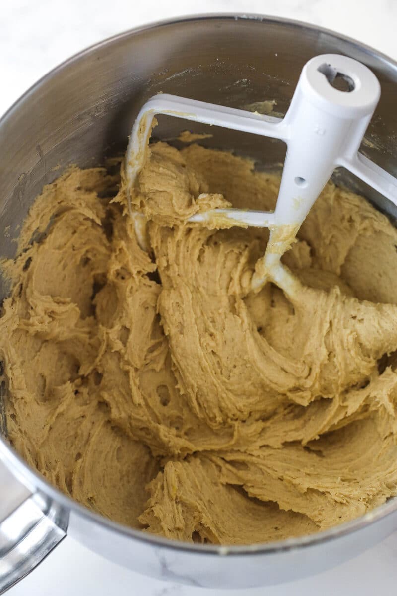 Mixing vanilla into cookie cake batter.