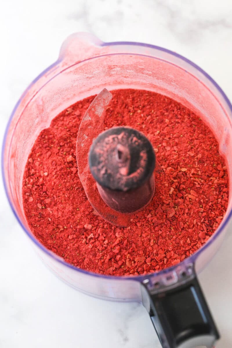 Turning freeze-dried strawberries into powder in a food processor.