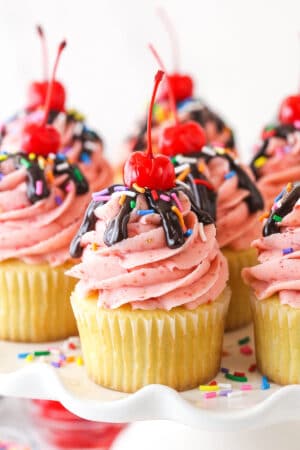 Closeup image of strawberry sundae cupcakes on a serving platter.