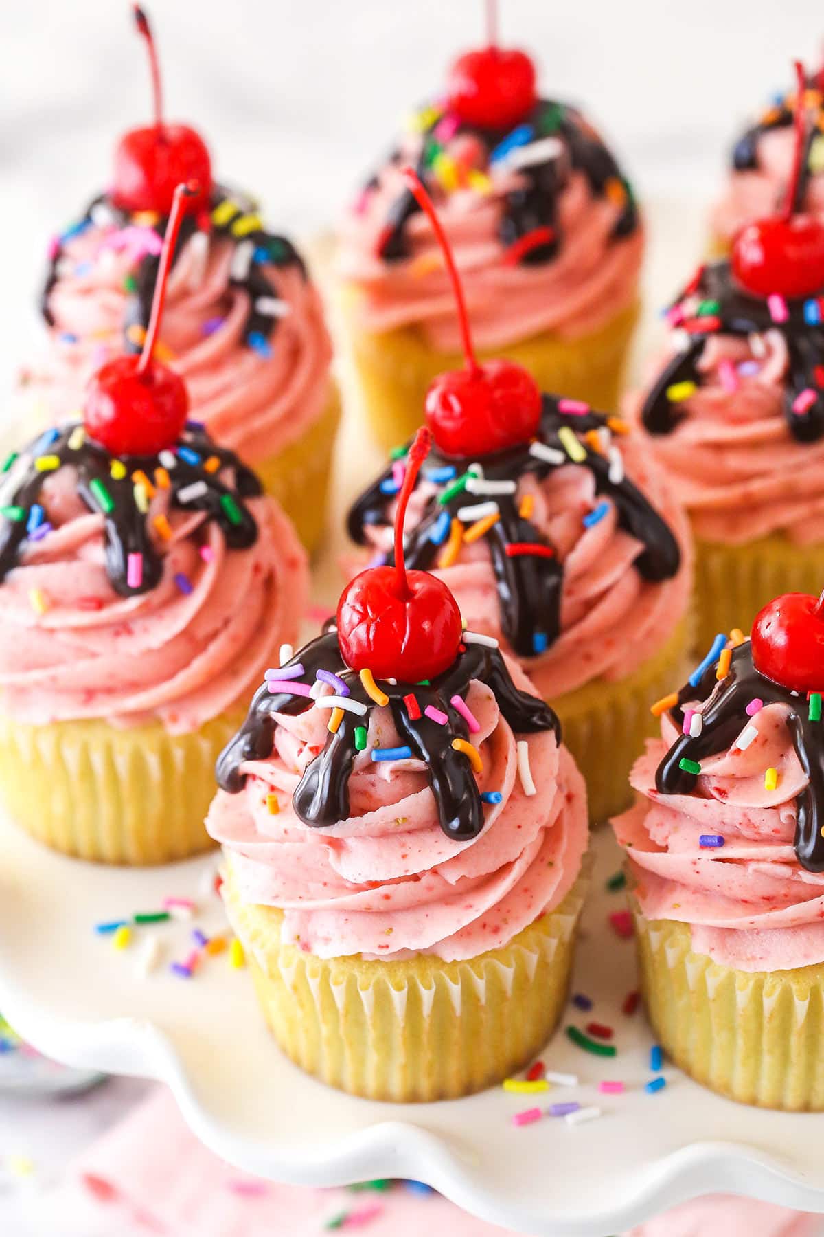 Overhead image of strawberry sundae cupcakes on a serving platter.