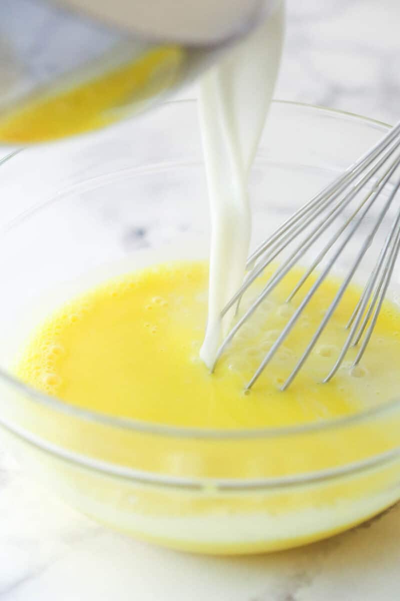 Tempering egg yolks to add to pudding.