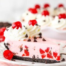 A slice of cherry chocolate ice cream pie on a plate.