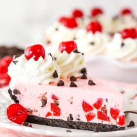 A slice of cherry chocolate ice cream pie on a plate.