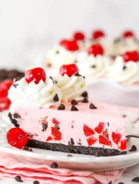 A slice of cherry chocolate ice cream pie on a plate.