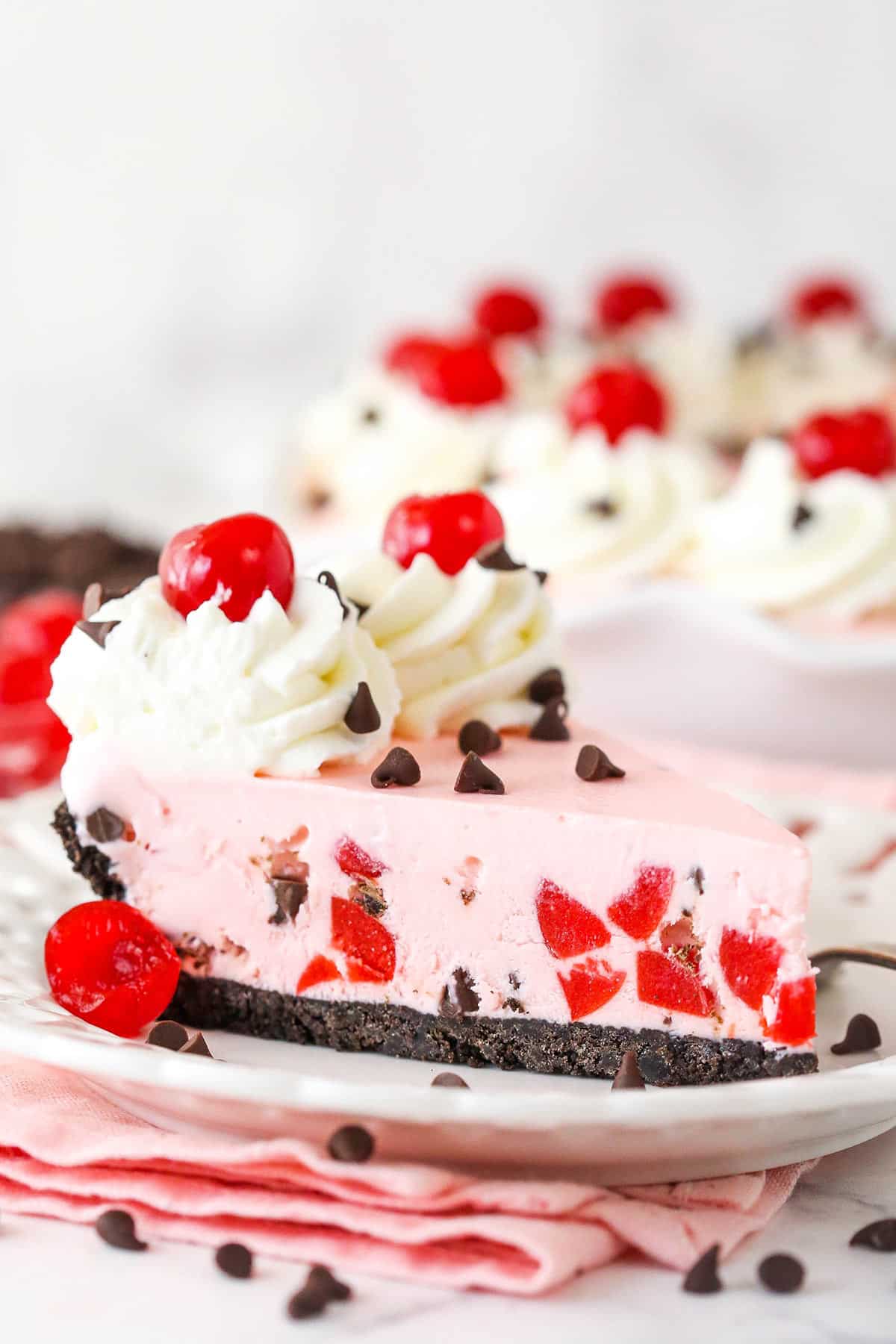 A slice of cherry chocolate ice cream pie on a plate.