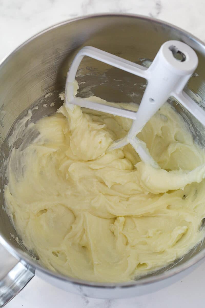 Mixing cream cheese, sugar, and flour together.