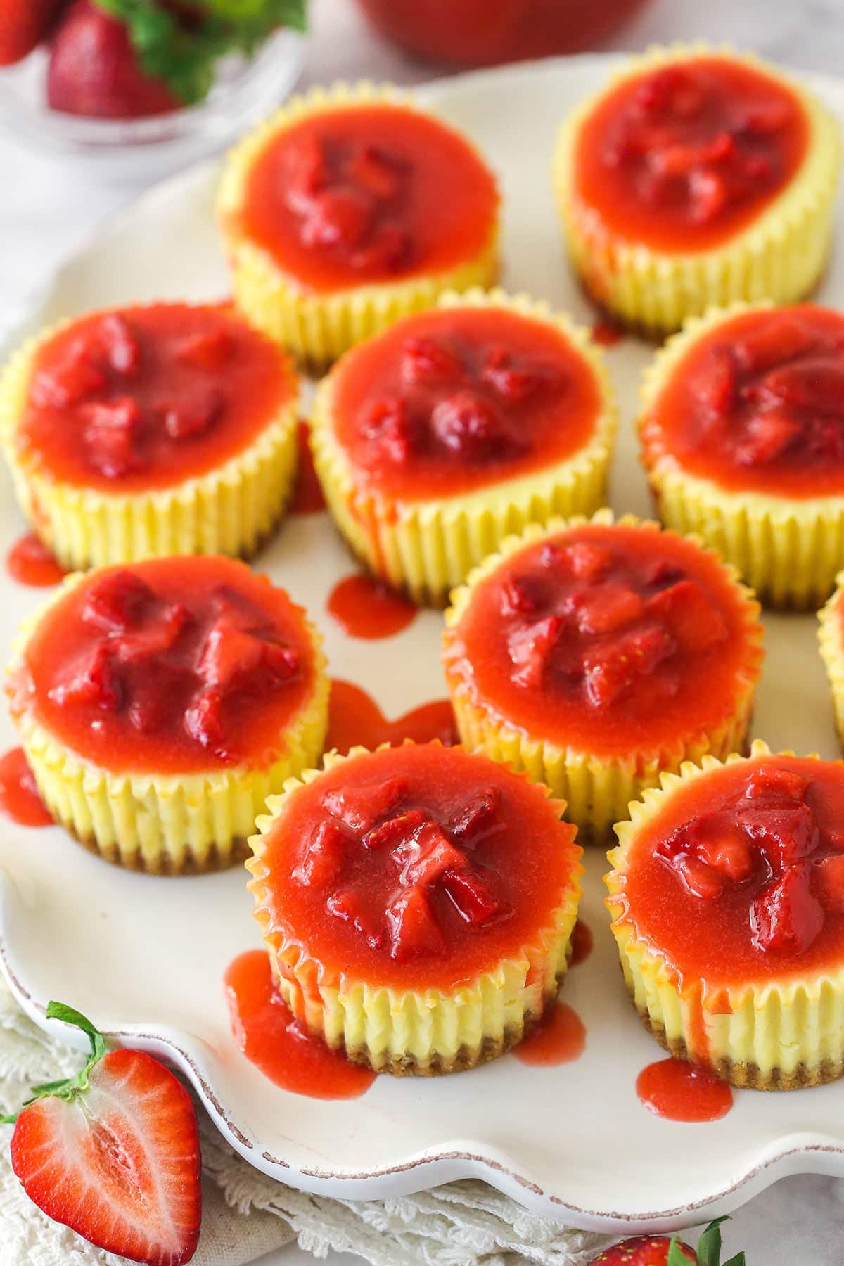 Overhead image of mini strawberry cheesecakes on a serving platter.