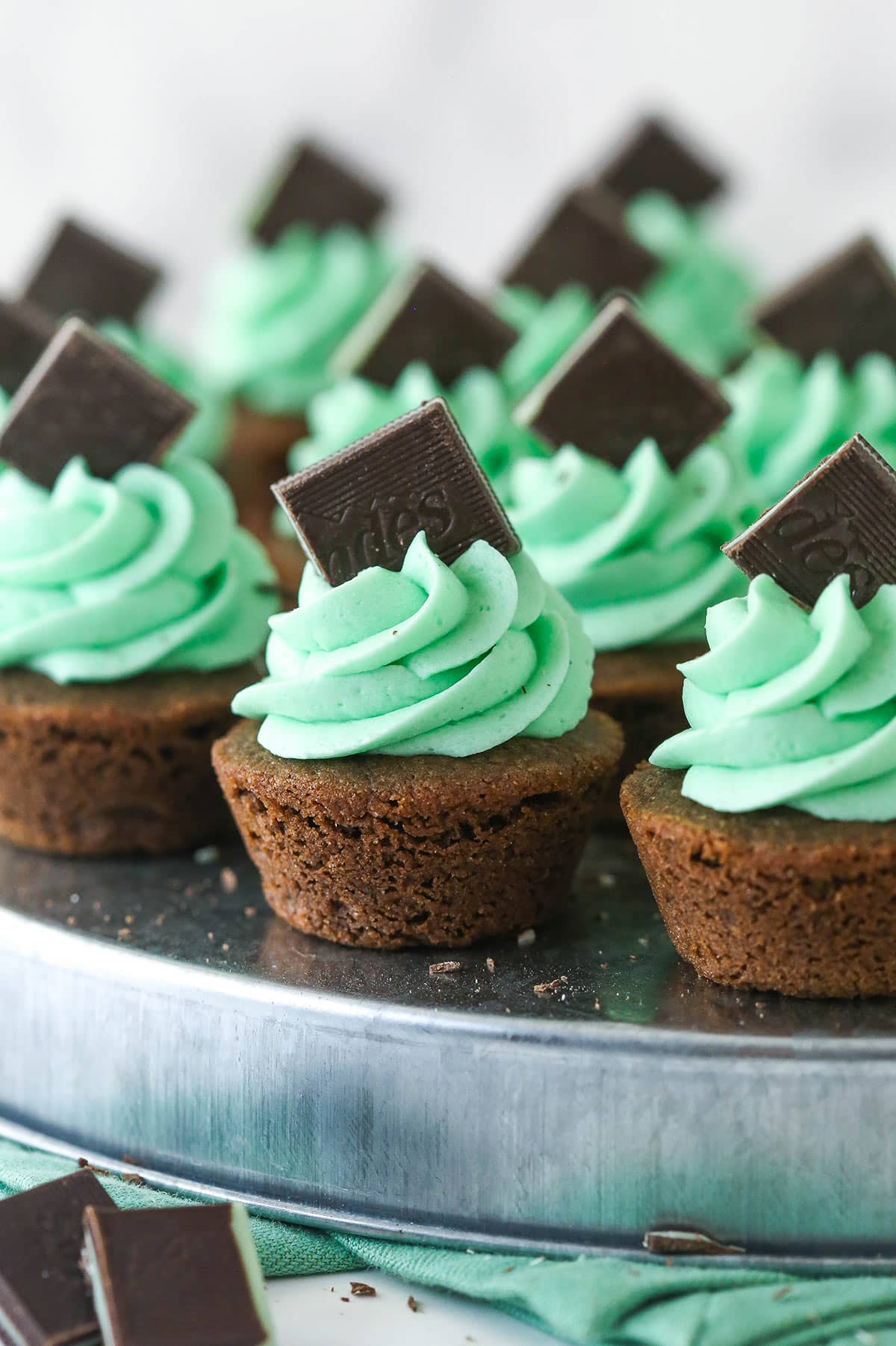 close up of mint chocolate cookie cup frosted with mint buttercream on a silver platter