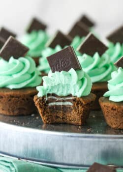 Mint chocolate cookie cup with a bite taken out of it so you can see the mint in the middle.