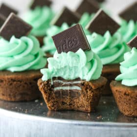 Mint chocolate cookie cup with a bite taken out of it so you can see the mint in the middle.