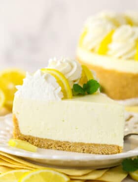 Side view of a slice of no bake lemon cheesecake on a plate.