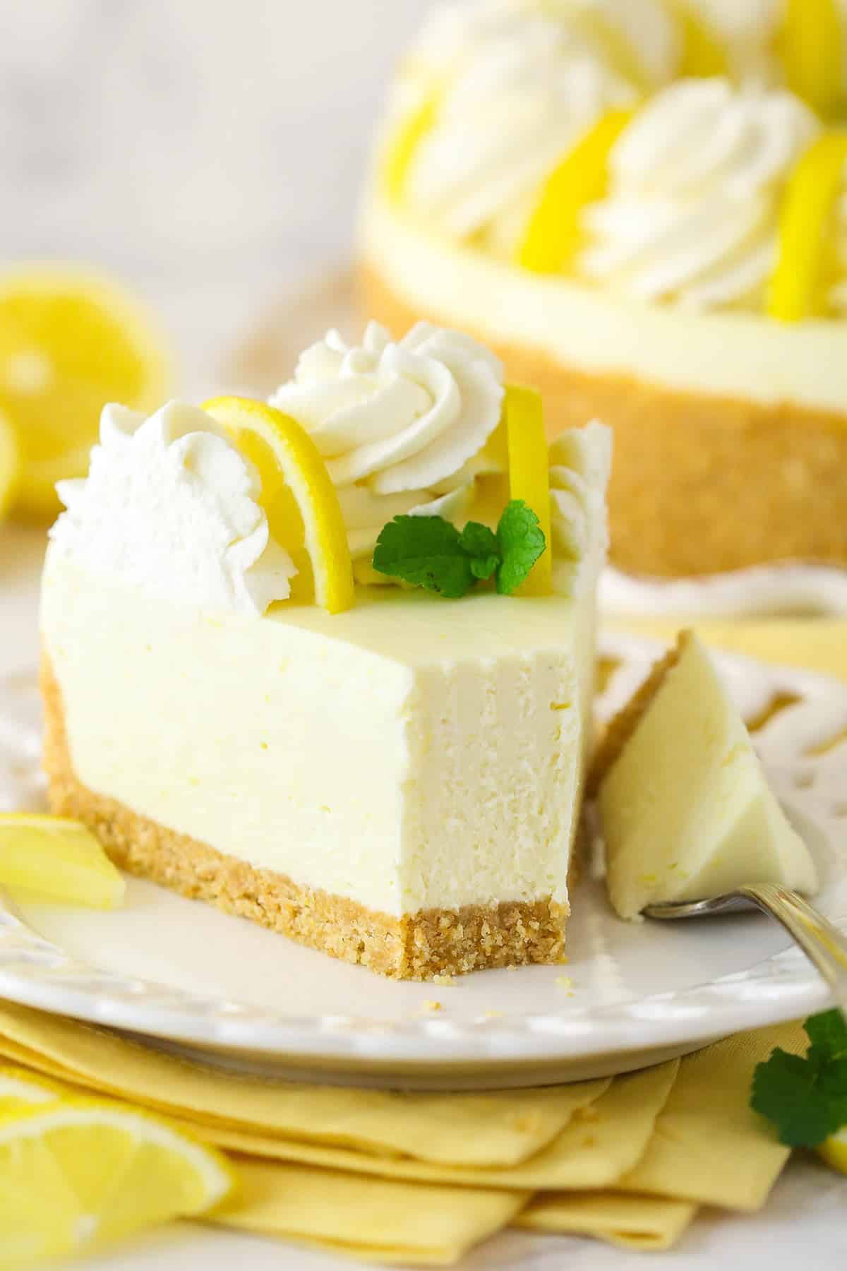 A slice of no bake lemon cheesecake with a bite taken out of it.