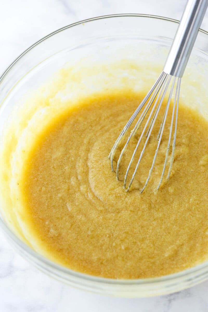 Whisking mashed bananas into the wet ingredients for banana chocolate chip cookie dough.