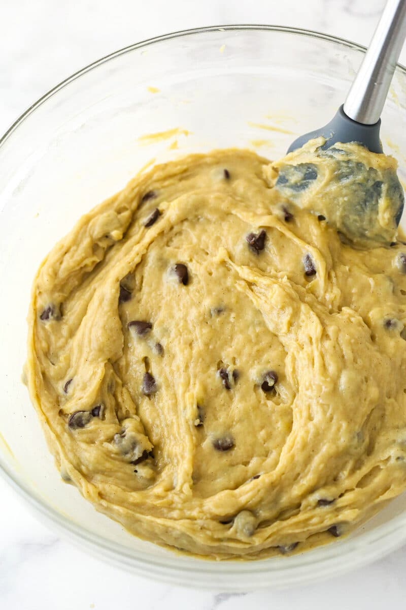 Folding chocolate chips into banana cookie dough.