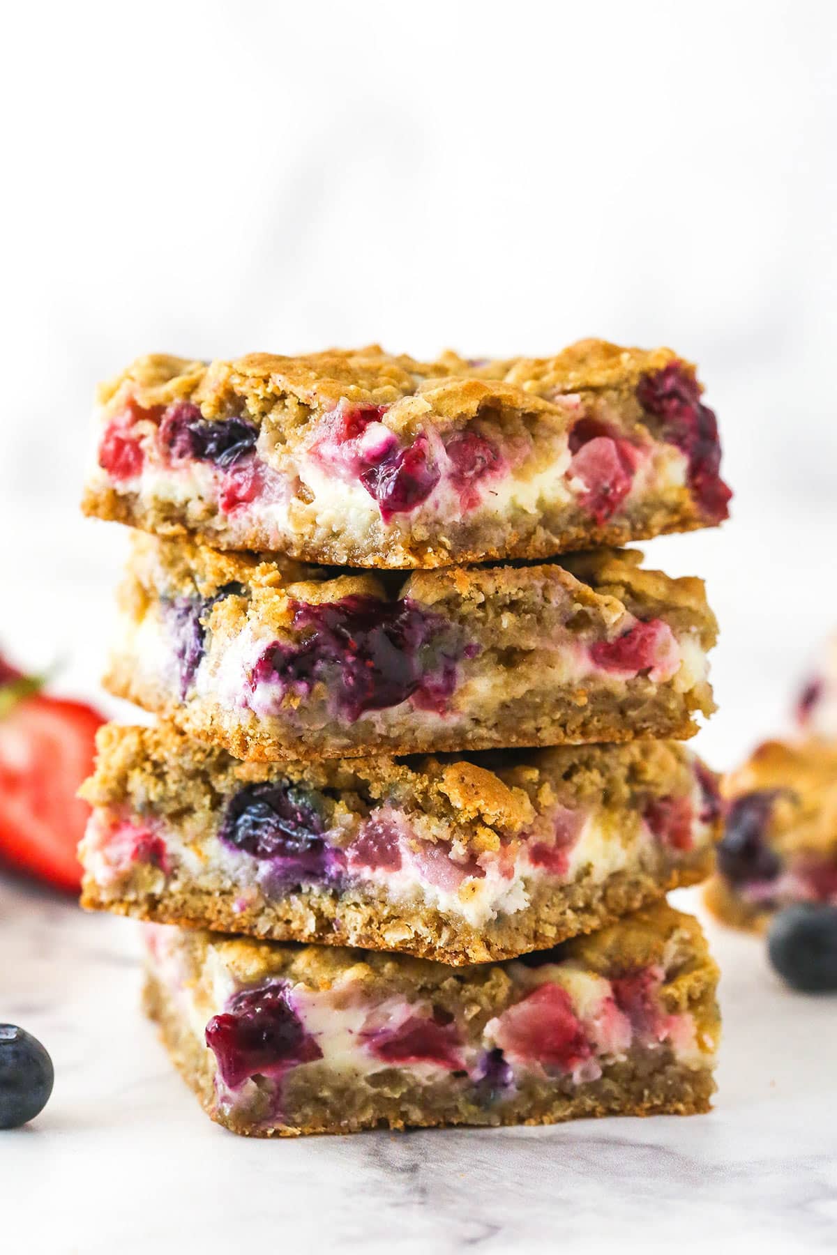 A stack of berry oatmeal cheesecake bars.