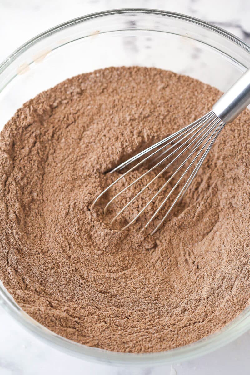 Whisking together the dry ingredients for chocolate poke cake.