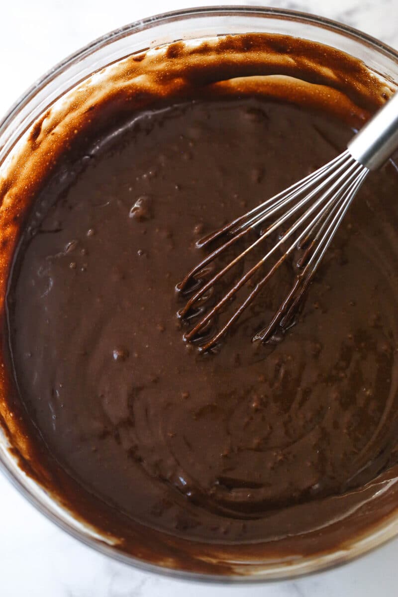 Combining the wet and dry ingredients for chocolate poke cake.