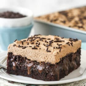 A slice of chocolate poke cake on a plate.