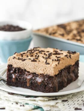 A slice of chocolate poke cake on a plate.