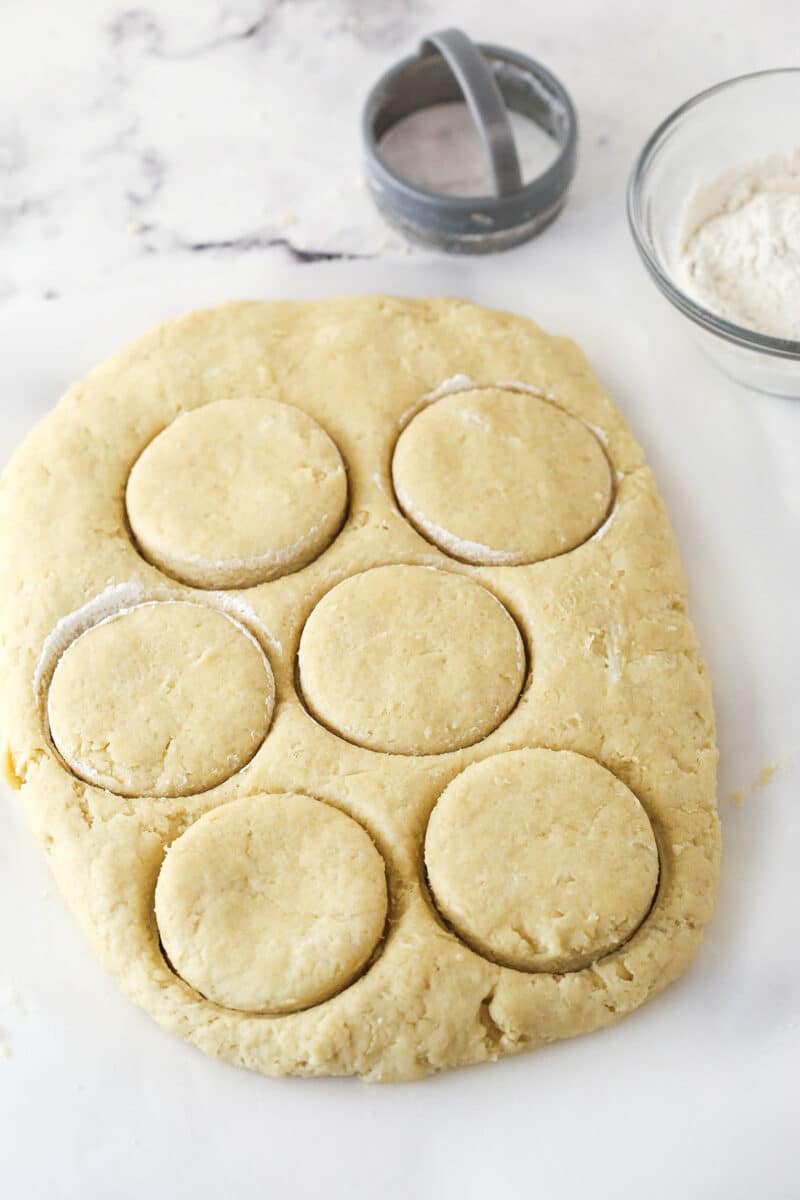 This strawberry shortcake recipe turns out cute, individual desserts made of flaky biscuits stuffed with juicy strawberries and whipped cream. Cutting shortcake biscuits out of shortcake biscuit dough.