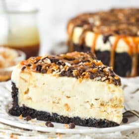 A slice of Samoa cheesecake on a plate.