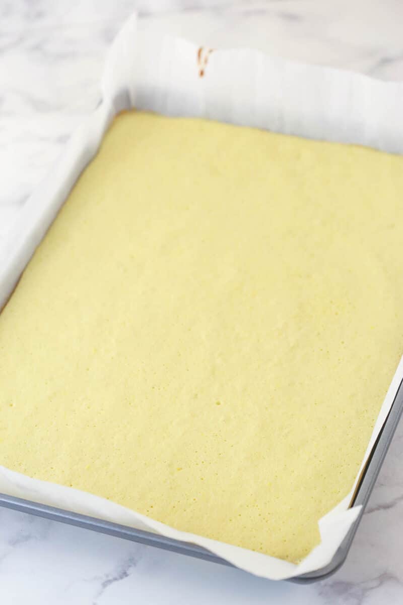 fully baked cake in a parchment lined pan