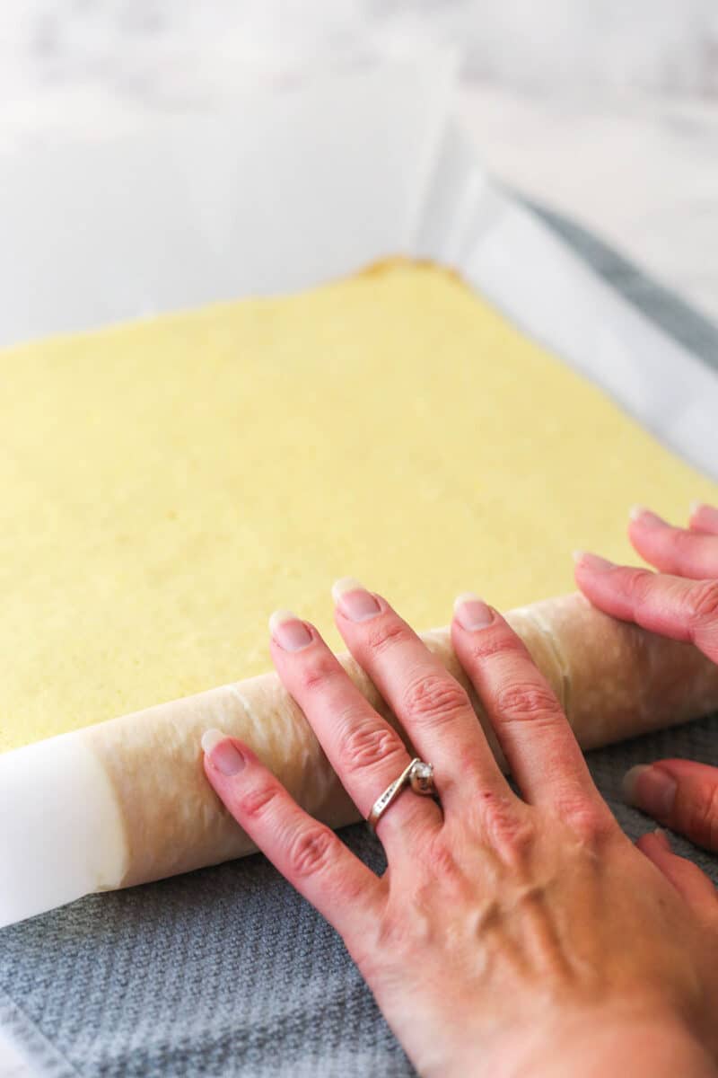 rolling the cake into a roll on the counter
