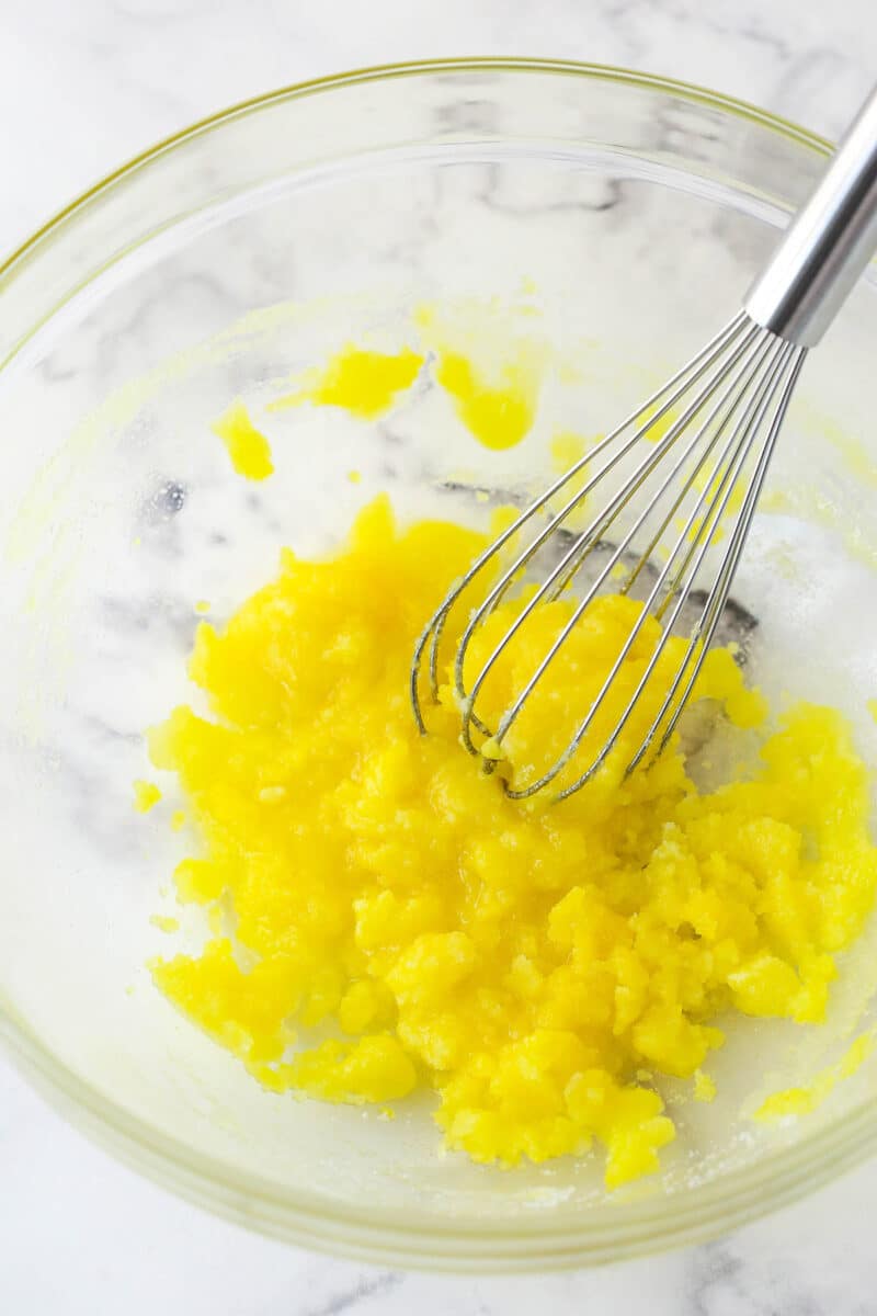 egg yolks and sugar mixed together in glass bowl