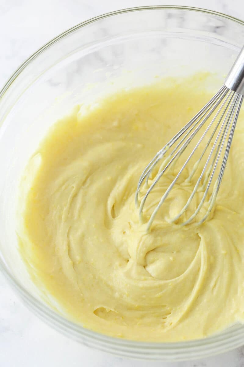 cake batter after adding the dry ingredients to the wet ingredients in glass bowl