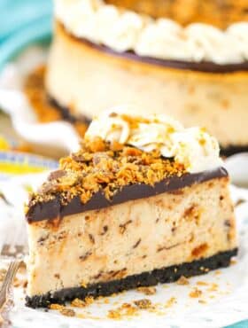 A slice of Butterfinger Cheesecake on a white plate