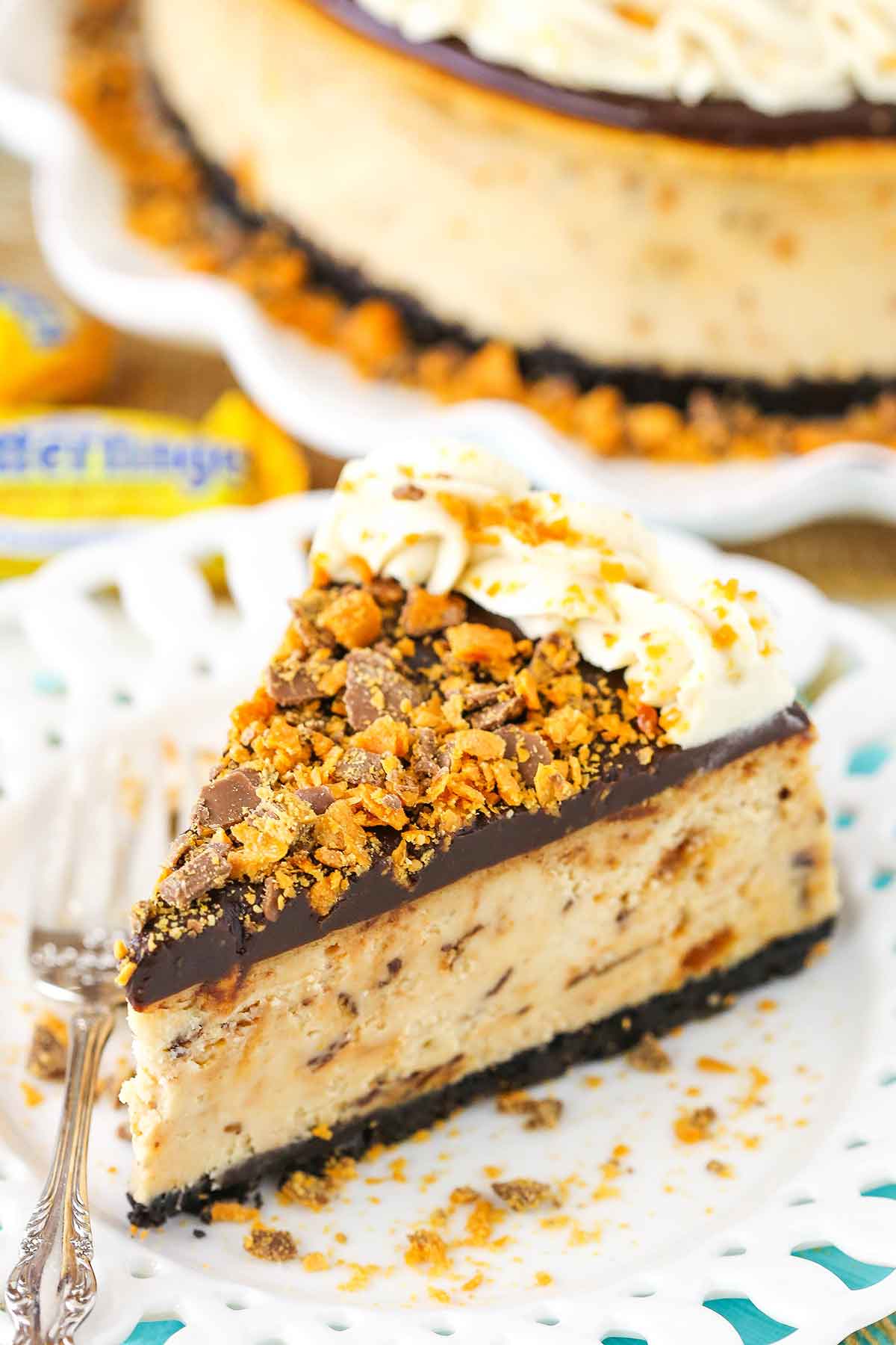 A slice of Butterfinger Cheesecake on a white plate
