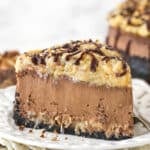 A slice of German chocolate cheesecake on a plate.