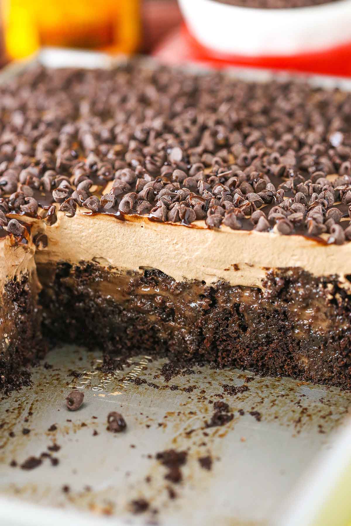 Kahlua Chocolate Poke Cake in a metal pan with a serving removed