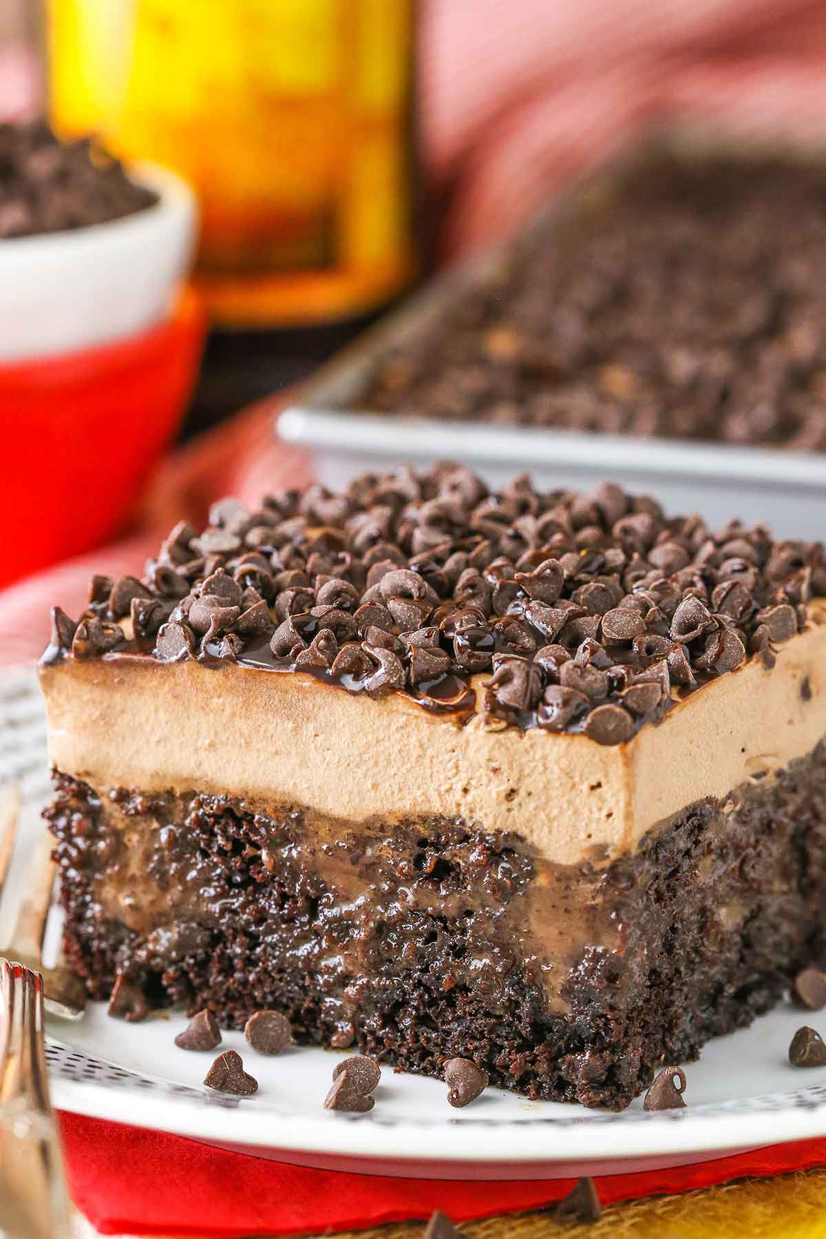A square slice of Kahlua Chocolate Poke Cake on a white plate