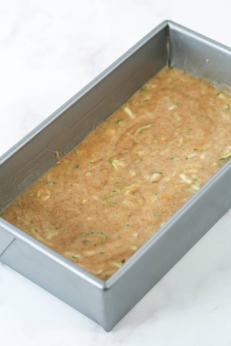When life gives you zucchini, make this zucchini bread! It's so moist, the perfect amount of sweet, and has a subtle hint of cinnamon to it. Zucchini bread batter in a loaf pan.